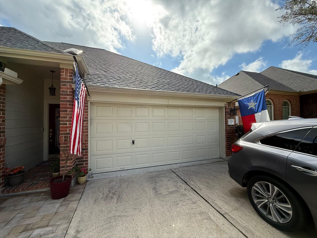 Completed garage door on a Texas home flying the US and Texas flags